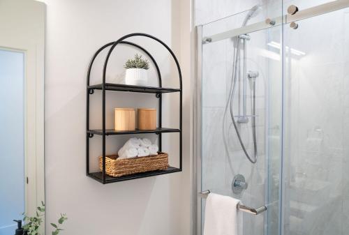 a bathroom with a black shelf next to a shower at The Big Deck by Revelstoke Vacations in Revelstoke