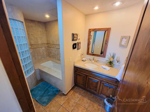 a bathroom with a tub and a sink and a shower at Bella Sirena Rocky Point by Castaways in Puerto Peñasco