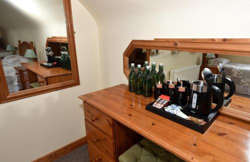 a counter with bottles on it in front of a mirror at Fishermans Village with Sea Views in Downings