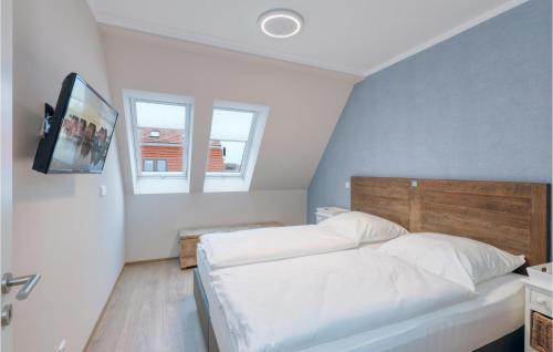 a bedroom with a bed and a tv on the wall at Baltischer Hof Apartment 57 in Boltenhagen