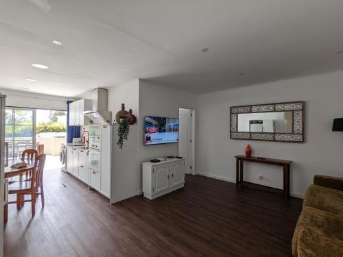 a living room with a kitchen and a dining room at VilaFplaza by JohnVillas in Portimão