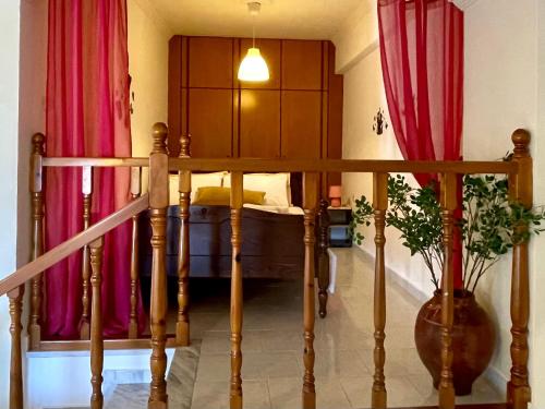 a bedroom with a bed with red drapes at Roumatsali home - Hidden 2BR historical gem in Chania Town