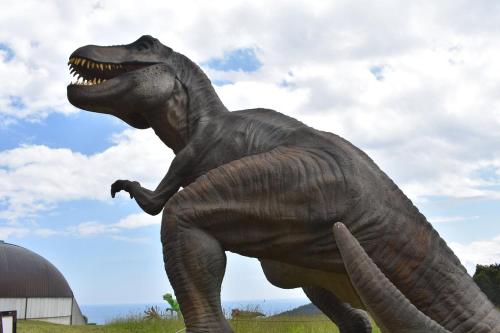 a statue of a dinosaur in a field at El Mirador del Sella in Arriondas