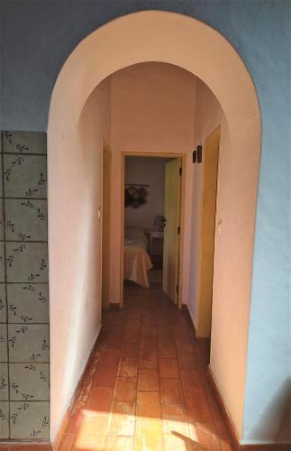 an empty hallway with an archway in a house at Monte da Choça in São Teotónio