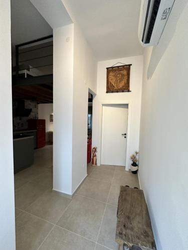 a hallway with a table and a white door at Apartments Urban in Poreč