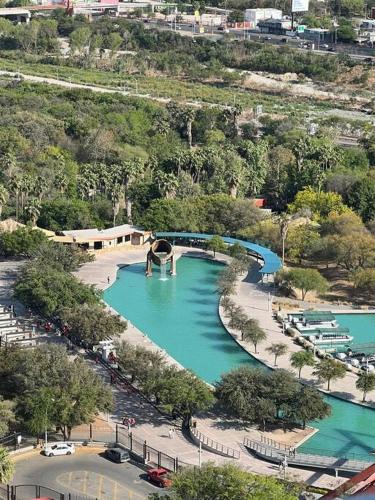 an aerial view of a river with blue water at Puntacero 1906 @fundidora in Monterrey