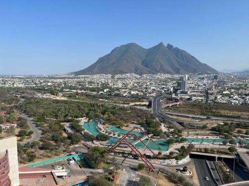 a view of a city with a mountain in the background at Puntacero 1906 @fundidora in Monterrey
