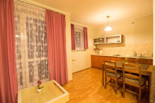 a living room with a dining room table and a kitchen at Happy Apartments - Economy in Wrocław