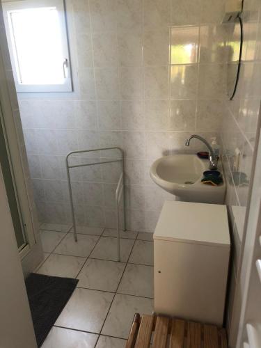 une salle de bain avec un lavabo, des toilettes et un miroir dans l'établissement Agréable maison familiale Proche De l'Océan Grand jardin, à Arthon-en-Retz