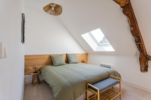 a bedroom with a bed and a skylight at L’orne in Caen