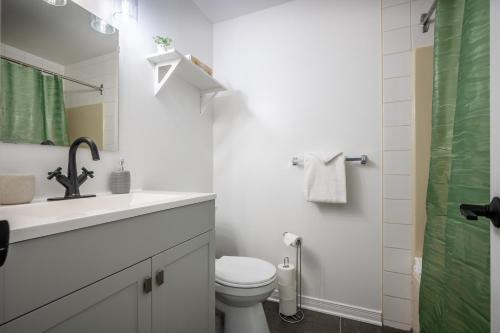 a bathroom with a toilet and a sink and a shower at Le Colvert by Rendez-Vous Mont-Tremblant in Mont-Tremblant