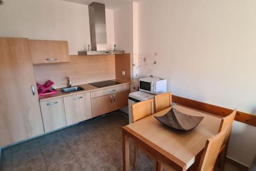 a small kitchen with a table and a microwave at Apartment Punta Umbría Luxury in Punta Umbría