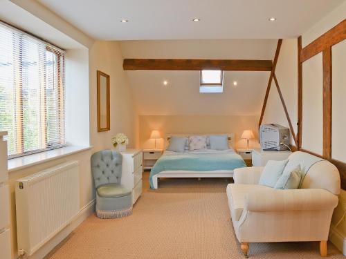 a bedroom with a bed and a couch at Fenn House in Alvechurch