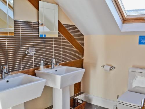 a bathroom with two sinks and a toilet at Fenn House in Alvechurch