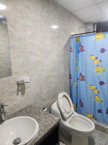 a bathroom with a toilet and a shower curtain at Mansión con piscina privada Villa Guiomar in Carmen de Apicalá