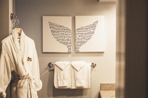 a bathroom with two pictures of wings on the wall at Avila Lighthouse Suites in Avila Beach