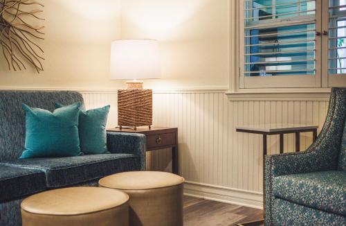 a living room with two chairs and a table at Avila Lighthouse Suites in Avila Beach
