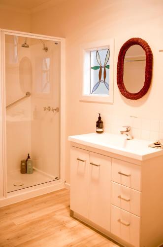 a bathroom with a sink and a shower at Lawrence creek cottage Bruny Island in Great Bay