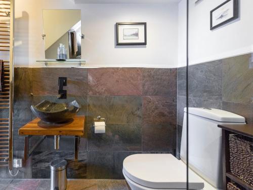 a bathroom with a toilet and a sink at Fern Cottage in Ardentinny