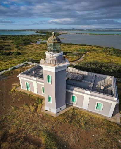 an aerial view of a light house with green windows at “La Choza” Beach Cabin en el Poblado de Boquerón in Cabo Rojo