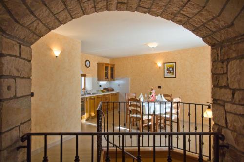 a kitchen and dining room with an archway in a house at Holiday Home Marta in Žminj