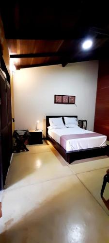 a bedroom with a large bed in a room at Hotel Amazon Bed And Breakfast in Leticia