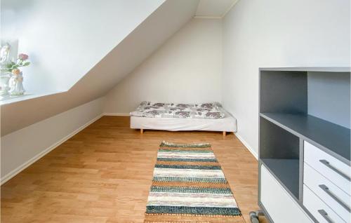 a room with a bed and a rug at 3 Bedroom Lovely Home In Simlångsdalen in Simlångsdalen