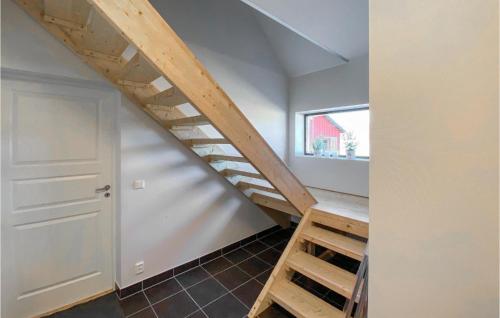 a staircase in a room with white walls and wooden ceilings at 3 Bedroom Lovely Home In Simlångsdalen in Simlångsdalen