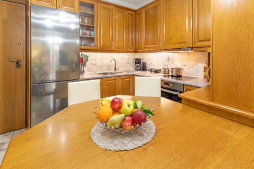 a bowl of fruit on a table in a kitchen at Johnny's Three Bedroom Apartment in Nafplio