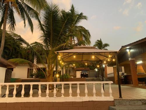 a house with a porch with lights on it at Uruka Lodge in Alajuela City