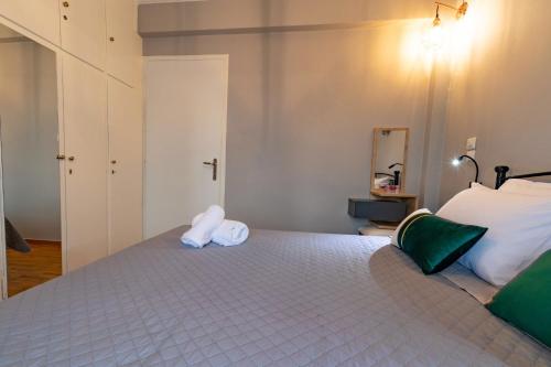 a bedroom with a bed with two towels on it at Johnny's Three Bedroom Apartment in Nafplio