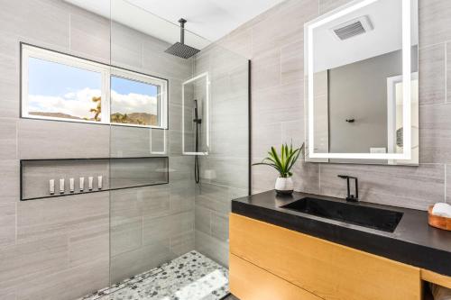 a bathroom with a sink and a mirror at Luxury Desert Retreat w Pool & Jacuzzi in Joshua Tree