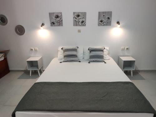 AsklipiḯonにあるIL PONTE room4のテーブル2台付きの客室で、白い大型ベッド1台が備わります。