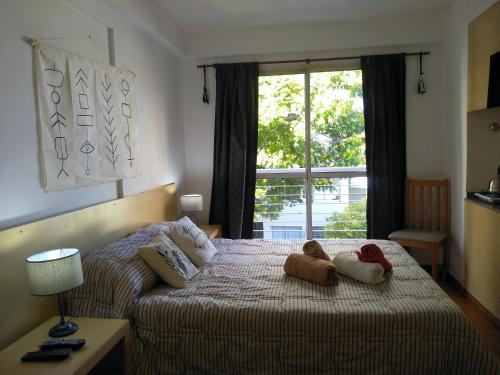 a bedroom with two teddy bears on a bed at Alquiler Balcarce in Rosario