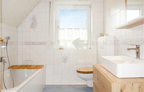 a bathroom with a sink and a toilet and a tub at Awesome Home In Drochtersen With Kitchen in Drochtersen