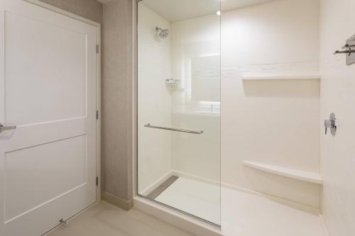 a bathroom with a shower and a glass door at Residence Inn Minneapolis Maple Grove/Arbor Lakes in Maple Grove