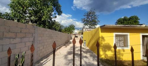 a fence in front of a yellow building at Casa los Jarochos in Valladolid