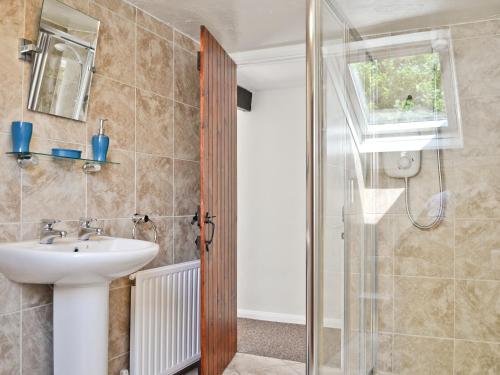 a bathroom with a sink and a shower at The Lodge - 29794 in Swimbridge