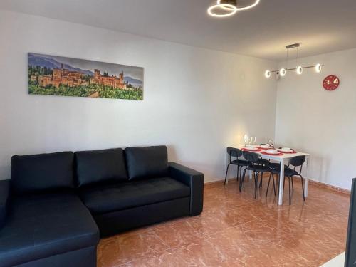 a living room with a couch and a table at Beach Apartment Artigas in Badalona