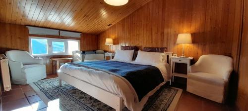 a bedroom with a bed and a chair in a room at Arrayanes Royal in Sierra Nevada