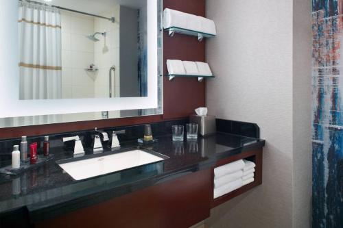 a bathroom with a sink and a mirror at Atlanta Airport Marriott Gateway in Atlanta