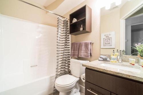 a bathroom with a toilet and a sink and a shower at Luxury, Hollywood Walk of Fame in Los Angeles