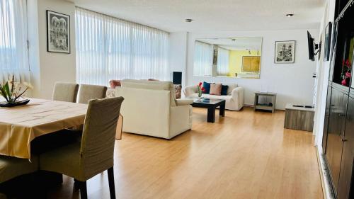 a dining room and living room with a table and chairs at Gelati apartment 1Parking 2BR 2BA in Mexico City