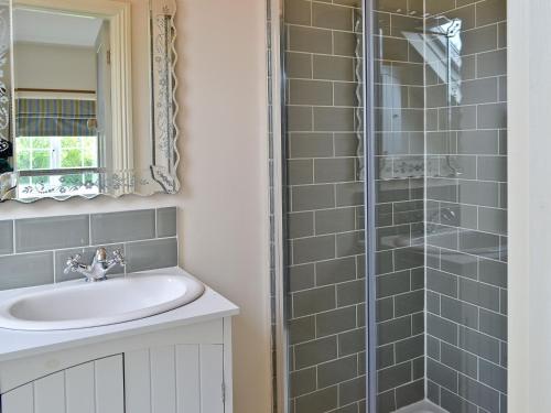 a bathroom with a sink and a shower at Barrowswood in Cheddar