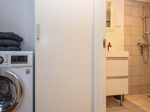 a bathroom with a washing machine and a sink at 4 person holiday home in Tønder-By Traum in Tønder