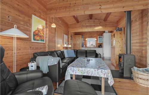 a living room with leather furniture and a stove at Amazing Home In Haderslev With Wifi in Haderslev