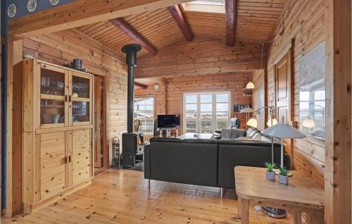 a living room with a black couch in a wooden house at Amazing Home In Haderslev With Wifi in Haderslev