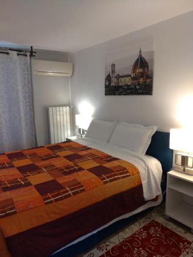 a bedroom with a bed with a quilt on it at Poggio Gherardo in Florence
