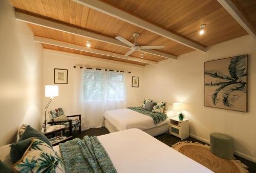 1 dormitorio con 2 camas y ventilador de techo en Pandora Beach House en Venus Bay