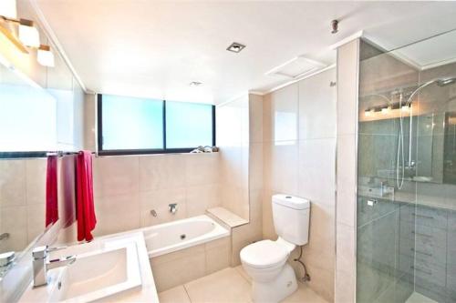 a bathroom with a toilet and a sink and a shower at Surfers Paradise Apartment With Amazing Views in Gold Coast